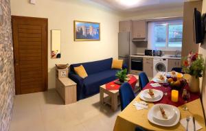 a living room with a blue couch and a kitchen at A&B Rhodes city apartments in Rhodes Town
