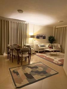 a living room with a couch and a table at شقه إيجار wesal in Madīnat ash Shurūq