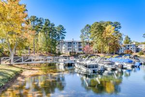 a group of boats are docked on a river at Boat, Golf and Swim Keowee Key Condo with Lake Views in Salem