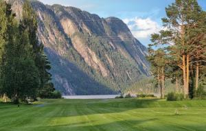 a golf course with a mountain in the background at Beautiful Home In Dalen With Harbor View in Dalen +15 photos