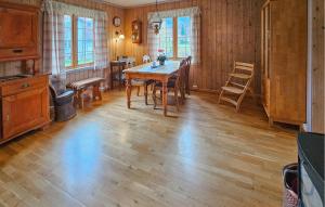 a dining room with a wooden table and chairs at Beautiful Home In Dalen With Harbor View in Dalen