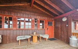 a wooden cabin with a table and two chairs at 4 Bedroom Gorgeous Home In Rjukan in Gaustablikk