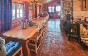 a long wooden table in a room with a fireplace at 4 Bedroom Gorgeous Home In Rjukan in Gaustablikk