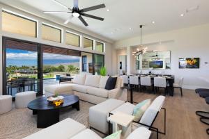 a living room with white furniture and a dining room at PiH: Hale Kailani Heated Private Pool Spa in Waimea