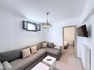 a living room with a couch and a tv at Villa Finoe 4 BDR with Private Pool in Plaka
