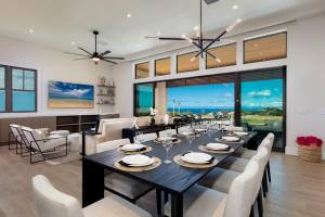 a dining room with a large table and chairs at PiH: Hale Kailani Heated Private Pool Spa in Waimea