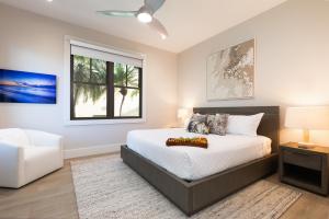 a bedroom with a bed and a window at PiH: Hale Kailani Heated Private Pool Spa in Waimea +92 photos