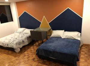 En eller flere senge i et værelse på Goldsmith Confort Suites Polanco