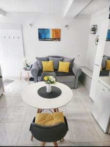 a living room with a table and a couch at Apartment Marina in Kotor
