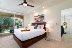 a bedroom with a large bed and a window at ❤PiH❤ Hono Loa BikesBeach Toys Private Beach Club in Waikoloa +33 photos