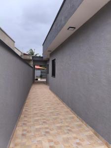 a hallway of a building with a concrete wall at Peruíbe nova in Peruíbe