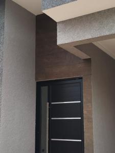 a black door in a room with a ceiling at Peruíbe nova in Peruíbe