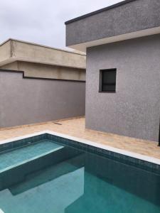 a swimming pool in front of a building at Peruíbe nova in Peruíbe +4 photos