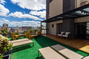 a balcony with a view of a city at Studios Sampa - Vila Buarque - Santa Casa in São Paulo