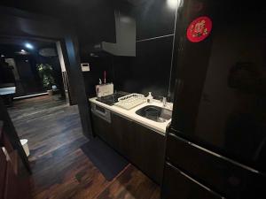 a kitchen with a sink and a counter top at いすみスローライフ in Chōjamachi +4 photos