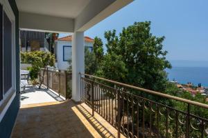 a balcony with a view of the ocean at Trithea Villa in Vlachata +22 photos