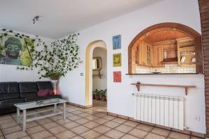 a living room with a couch and a table at Cal Sopas in Collbató