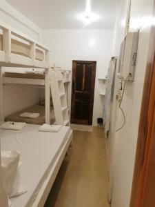 a room with two bunk beds and a hallway at Latitude 10 Siargao in General Luna