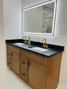a bathroom with a sink and a large mirror at The Marietta Haus in Marietta +8 photos