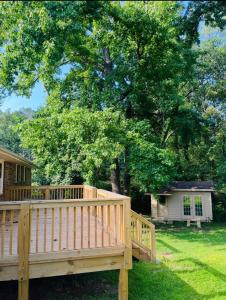 a wooden deck in front of a tree at The Marietta Haus in Marietta