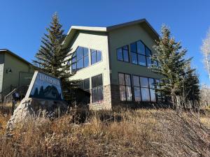 a house with a welcome sign in front of it at Summit County Wildernest Condo in Silverthorne