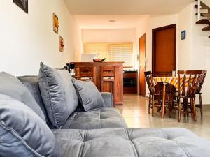 a living room with a couch and a table with chairs at Casa Vista Verde in Paraty