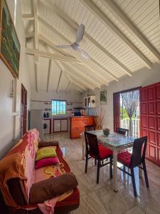 a living room with a couch and a table at Gîte Soleil Canne in Capesterre-de-Marie-Galante