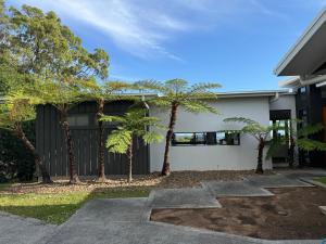 a house with palm trees in front of it at Hilltop Getaway in Ocean View