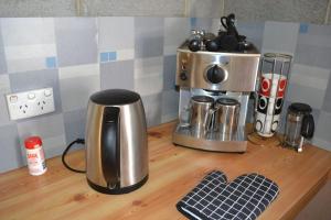 a counter top with a coffee maker and a coffee pot at Sound Of The Surf in Evergreen