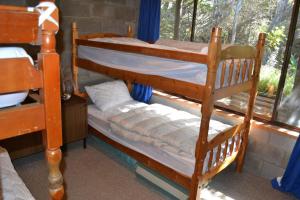 two bunk beds in a room with a window at Sound Of The Surf in Evergreen