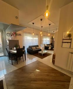 a living room with a couch and a table at Alloggio Turistico in Via Zotti in Lido di Ostia