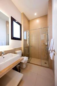 a bathroom with a shower and a sink and a toilet at Luxury Stays in Cyan El Gouna in Hurghada