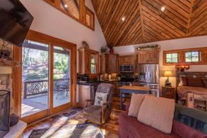 a living room with a couch and a kitchen at River Sound Cabin at Eagles Nest in Banner Elk