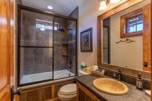 a bathroom with a sink and a tub and a toilet at River Sound Cabin at Eagles Nest in Banner Elk