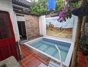 a swimming pool in the middle of a house at Hostal Rolled in Villavieja