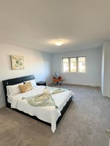 a bedroom with a large bed and a chair at Charming Stay in London in London