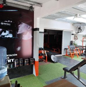 a room with a large poster on the wall at Trainer Center House in Tres Arroyos