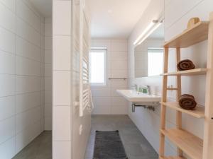 a bathroom with a sink and a mirror at JooP in Niedernsill +38 photos