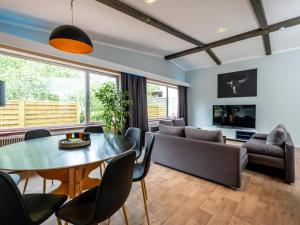 a living room with a table and chairs at Haslau Large in Hopfgarten im Brixental