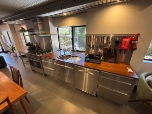 a large kitchen with stainless steel appliances and a table at 24 Elizabeth in Oxford Park