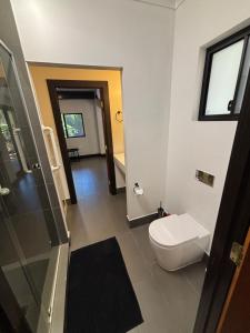 a bathroom with a toilet and a walk in shower at 24 Elizabeth in Oxford Park +4 photos