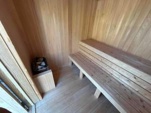 a sauna with two wooden benches in a room at いすみスローライフ in Chōjamachi