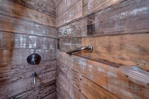 a bathroom with a wooden wall with a sink at Romina Art Hotel in Villa Gesell +120 photos