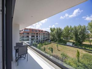 a balcony with a desk and a view of a building at Apartment in Middelkerke with balcony in Middelkerke