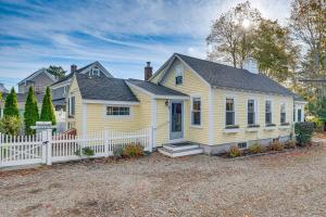 a yellow house with a white fence at Kennebunk Cottage with Yard Less Than 1 Mi to Beach! in Kennebunk