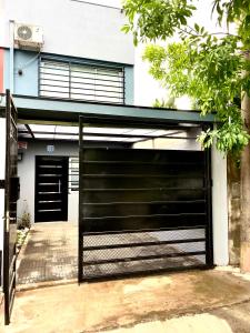 a black garage door in front of a building at Orillas del Sol Triplex in Chascomús +38 photos