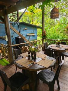two wooden tables and chairs on a wooden deck at Majagua in Bahía Solano