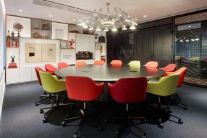 a conference room with a table and chairs at citizenM Washington Capital in Washington