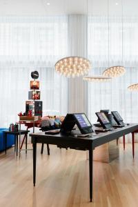 a table with laptops on it in a room at citizenM Los Angeles Downtown in Los Angeles