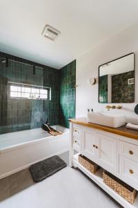 a bathroom with a tub and a sink and a mirror at Paddle Point in West Milford +22 photos